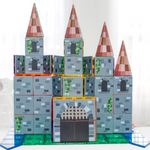  castle made from magnetic tile toppers sitting on table with curtain behind