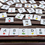 Alphabet Upper Case Pack displayed sitting on magnetic tiles on a wooden table