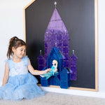 Girl dressed in frozen dress playing with Elsa in a castle displayed on chalkboard of multi-board