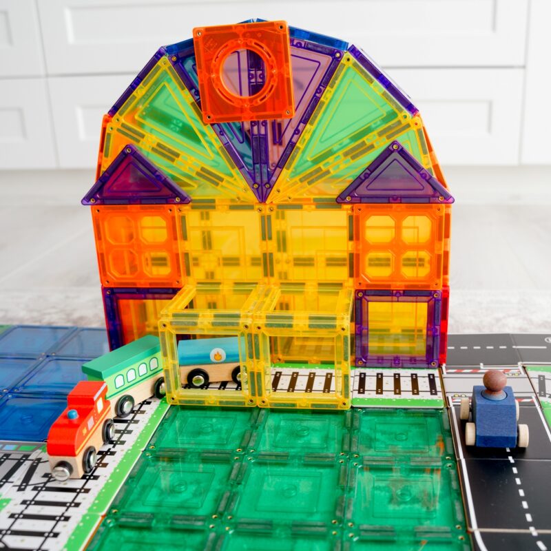 Colourful station made from learn and grow magnetic tiles set up with train and road toppers