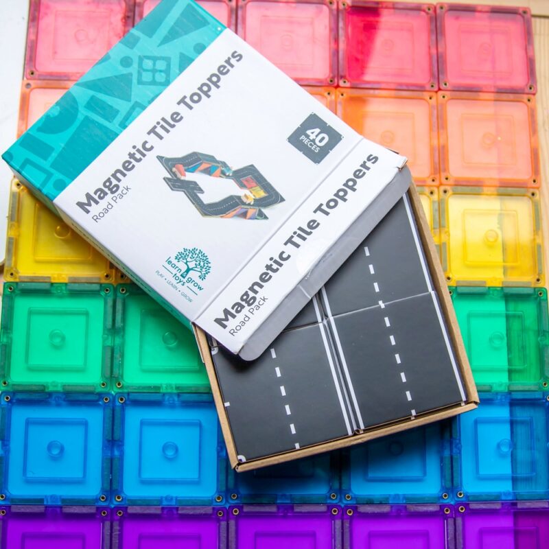 Road pack toppers int their packaging sitting on rainbow magnetic tiles