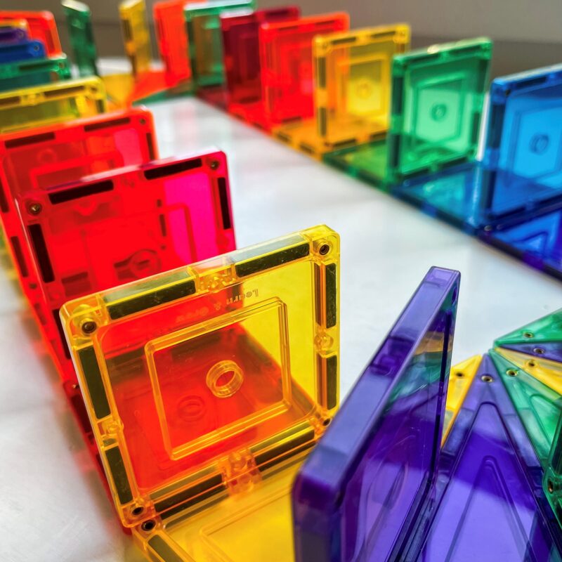 Small rainbow squares set up like dominoes
