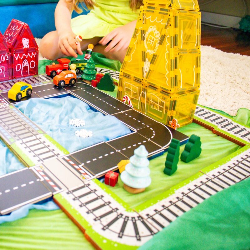 Train and road toppers used with magnetic tile houses and Sarah's Silks and a child playing