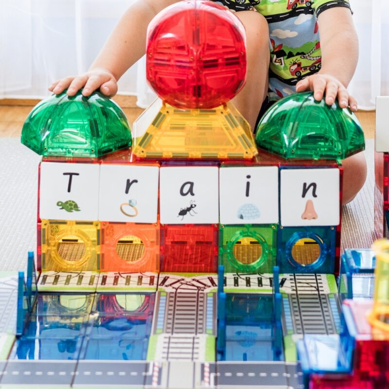 Train toppers used with domes and a child sitting with his play build