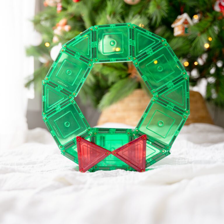 Christmas wreath made from magnetic tiles from learn and grow toys with christmas tree in background