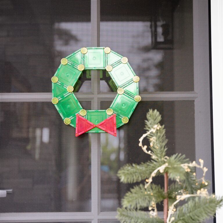 Christmas wreath on door made from learn and grow toys magnetic tiles