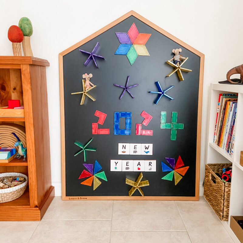 Learn & Grow Toys Multi-Board on wall in a playroom showing 2024 on chalkboard