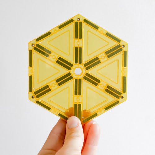 Hand holding yellow hexagon showing strong 24 magnets